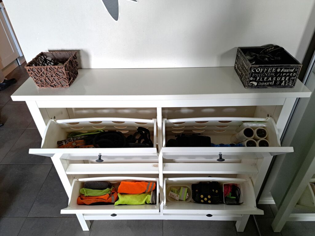 Kenkäkaappiin on järjestetty eteisen tavaroita väljästi ja toimivaan järjestykseen.